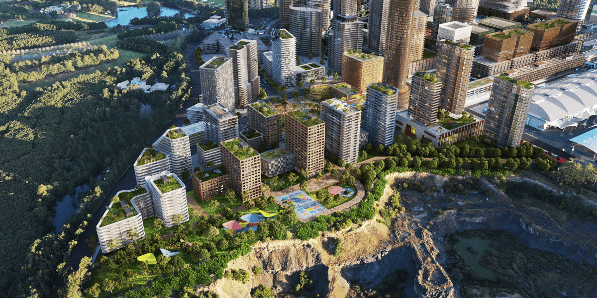 A rendered aerial view of the Sydney Olympic Park Master Plan 2050 showing a high-density, mixed-use precinct with green-roofed buildings, public spaces, and surrounding parklands.